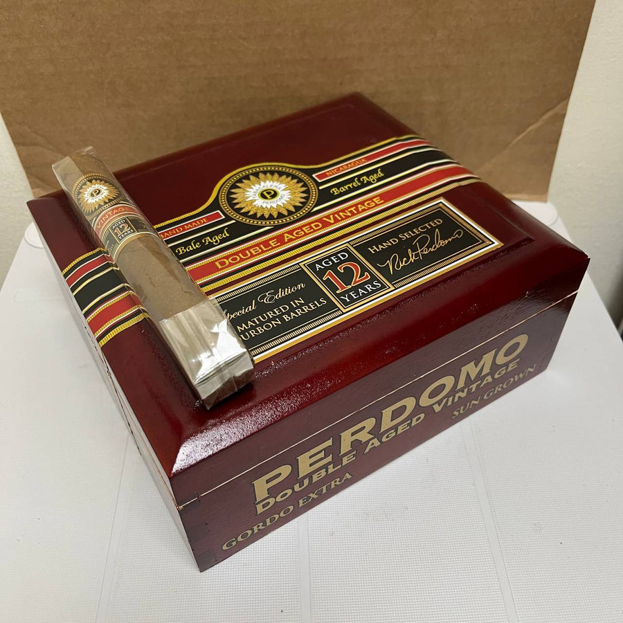 Perdomo Double Aged Vintage cigar with a box on a white surface